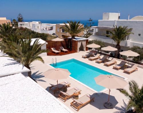 an image of a swimming pool with chairs and umbrellas at Breaq Santorini - Margarita Hotel in Firostefani