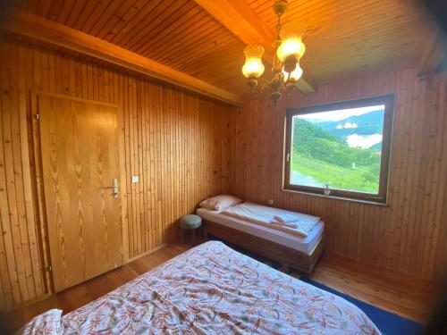 a bedroom with two beds and a window at Panorama Hause in Podplat