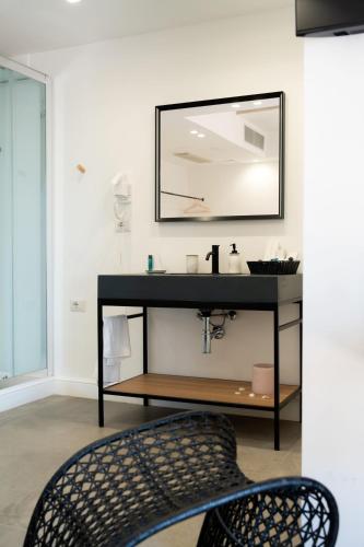 a bathroom with a sink and a mirror at Didimos Resort in Reggio di Calabria