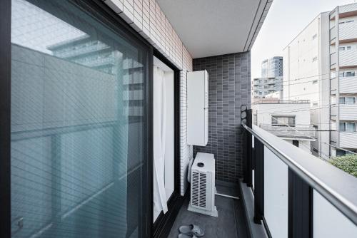 a balcony with a window and a heater at Maple Hotel Tokyo in Tokyo