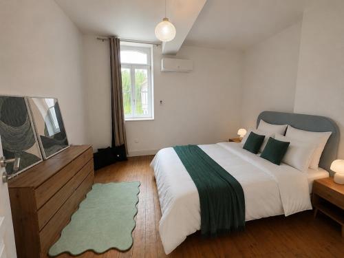 a bedroom with a large bed and a window at Maison de ville hypercentre Béthune in Béthune