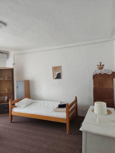 a bedroom with a bed in the corner of a room at Natasa in Bačka Palanka