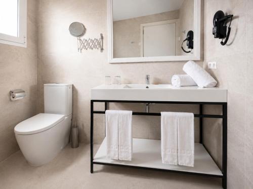 a white bathroom with a sink and a toilet at Cabot Sivella Apartments in Port de Pollensa