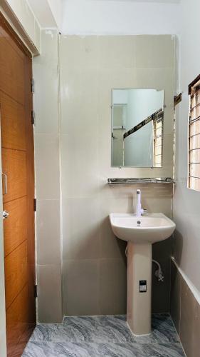 a bathroom with a sink and a mirror at Hotel New Kalabagan in Dhaka