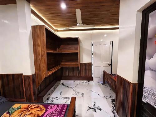 an empty room with a bed and a closet at Misty valley Private Pool Villa Munnar in Anachal