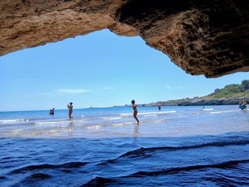 a group of people in the water at the beach at B&B Casa Desimio in Vieste