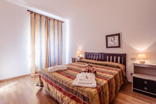 a bedroom with a bed with two dolls on it at Le Terrazze in Follonica