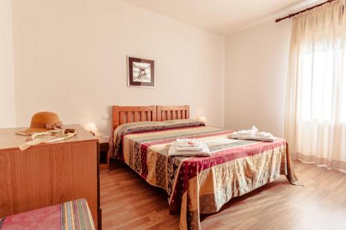 a hotel room with two beds and a window at Le Terrazze in Follonica