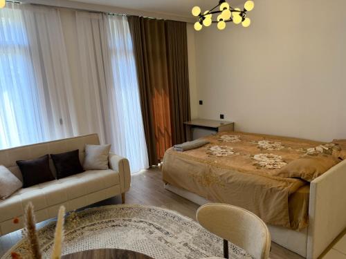 a living room with a bed and a couch at Ugam Mountain apartments in Khumson