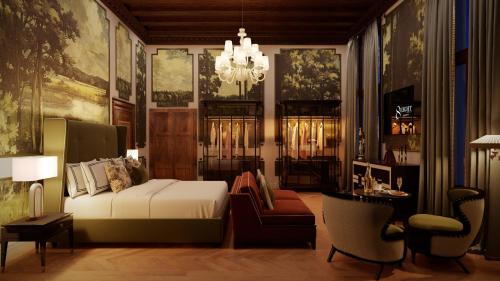 a bedroom with a bed and a couch and a chandelier at Eight Venezia in Venice