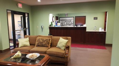 a living room with a couch and a bar at Super 8 by Wyndham Central City in Central City