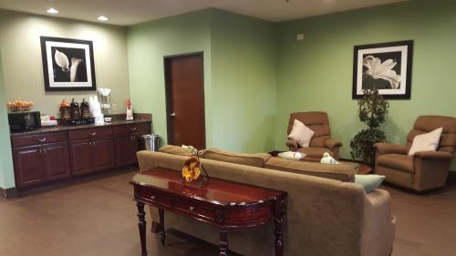 a living room with a couch and a table at Super 8 by Wyndham Central City in Central City