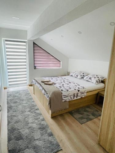 a bedroom with a bed and a window at Vikendica Teodora - Zvornik in Zvornik