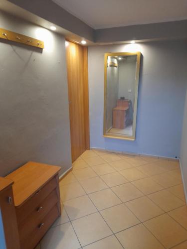 a room with a mirror and a tile floor at Malwers in Zielonka