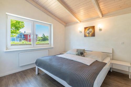 a bedroom with a bed and a window at Ferienhaus Süderoog in Dagebüll