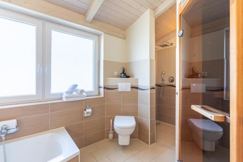 a bathroom with a toilet and a sink at Ferienhaus Süderoog in Dagebüll