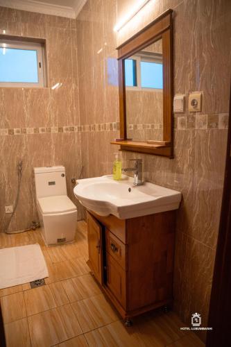 a bathroom with a sink and a toilet at Hotel Lubumbashi Golf in Lubumbashi