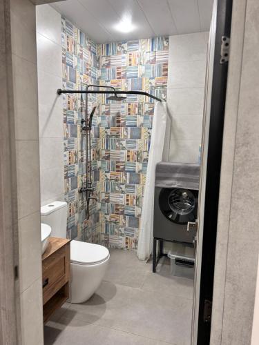 a bathroom with a toilet and a shower at Your Cozy Home 2BR Local Vibe 25 Mins to Center in Yerevan