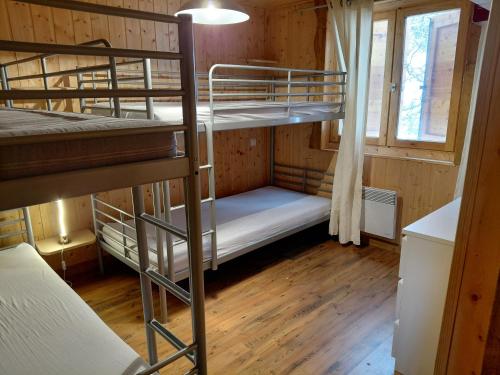 a room with two bunk beds and a window at La Tapia in La Foux d'Allos