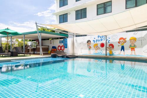 a swimming pool at a hotel at Movenpick Suriwongse Hotel Chiang Mai in Chiang Mai