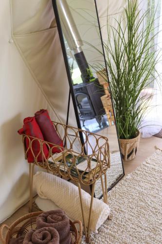 a room with a chair in front of a tent at Glempingosta in Bauska