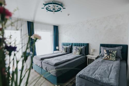a bedroom with two beds and a table and a window at WPO - WILD PIKE OASIS in Caraorman