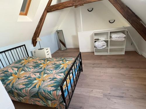a bedroom with a bed in a attic at Logis de l'Éperon Laon in Laon