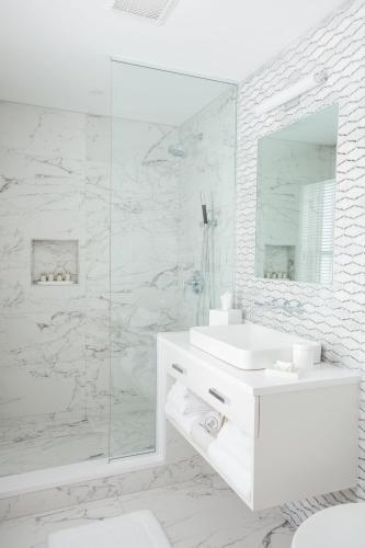 a white bathroom with a sink and a mirror at 33 Main in Lenox