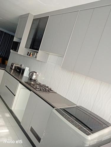 a kitchen with white cabinets and a counter top at Green Harvest BnB in Newmansford