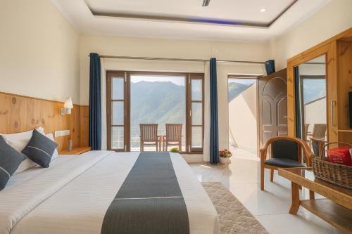 a bedroom with a large bed with a view at The Four Season Resort, Mussoorie - top rated & most awarded property in mussoorie in Mussoorie