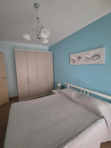 a bedroom with a bed and a blue wall at Le Dune per 4 - Appartamento con piscina in Silvi Paese
