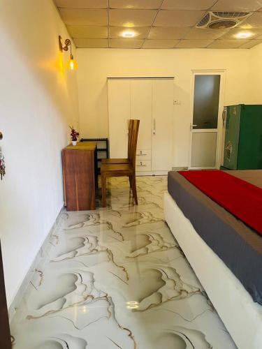 a bedroom with a bed and a table and a chair at Coastal Bliss in Dickwella