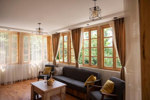 a living room with a couch and some windows at Laguna Villa Cottages in Chinkadzeebi