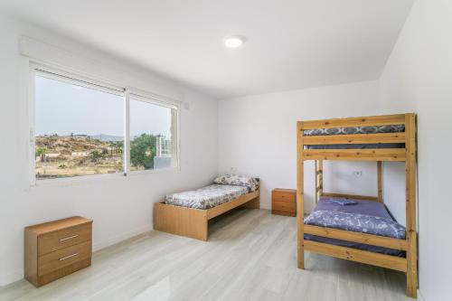 a bedroom with two bunk beds and a window at Bender House in Moralet