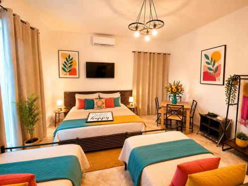 a hotel room with two beds and a tv at Gioia B&B in Cirò Marina