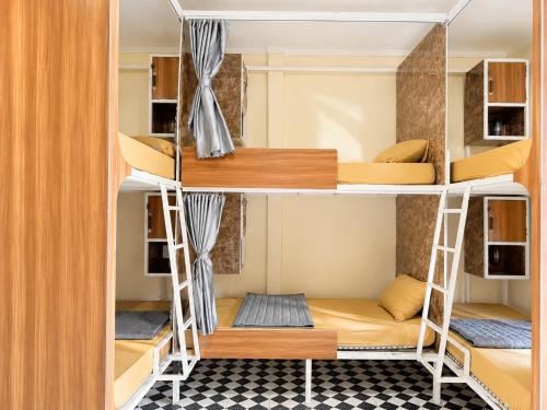 a room with bunk beds in a hostel at Vang Vieng Dragon House in Vang Vieng