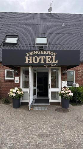 a hotel with a sign on the front of a building at Hotel Esingerhof by Alesta in Tornesch