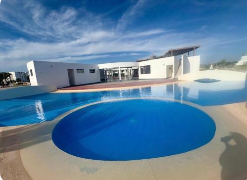 a large swimming pool in front of a house at Ocean View Apartment Beach Pools Pier & Lift in Paracas