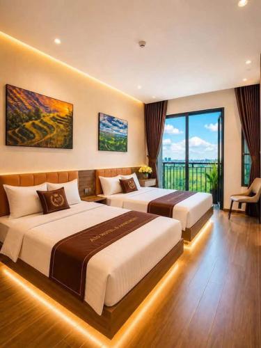 a hotel room with two beds and a balcony at A30 Hotel & Apartment in Lưu Xá