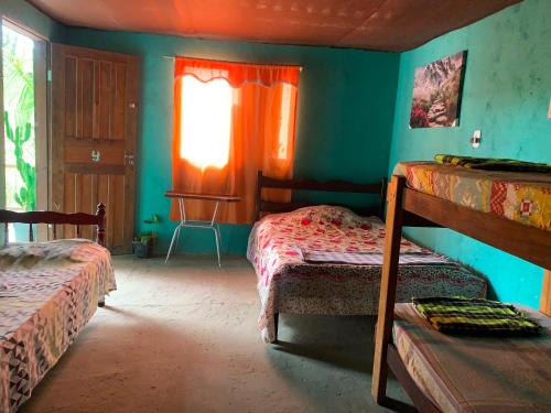 a room with two bunk beds and a window at Pousada Suíte Conexao in Conceição da Barra