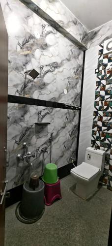a bathroom with a sink and a toilet in a room at Hampi Lake House in New Hampi
