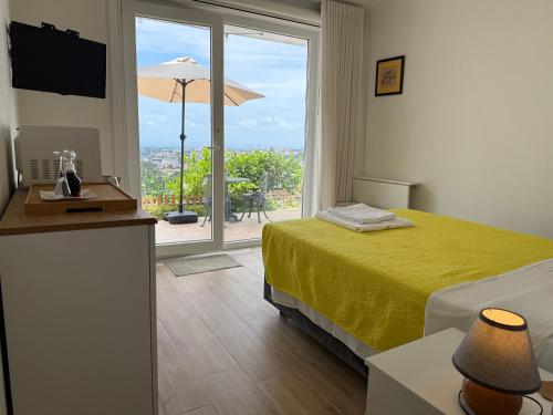 a hotel room with a bed and a large window at Alfazema Sunset House in Vila Nova de Gaia