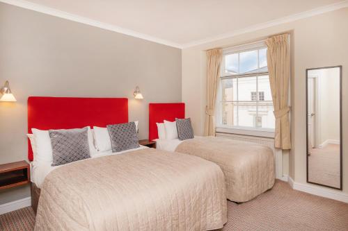 a hotel room with two beds and a window at The Clifton Hotel Bristol in Bristol