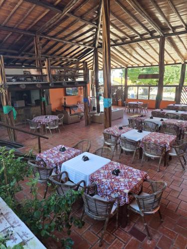 a patio with tables and chairs in a pavilion at Fantasia do Agreste in Jandaíra
