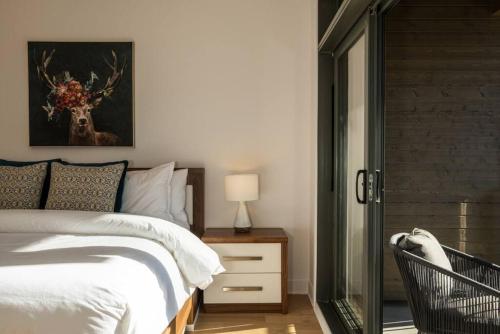 a bedroom with a bed with a deer painting on the wall at Tremblant Prestige - Verbier 3-201 in Mont-Tremblant