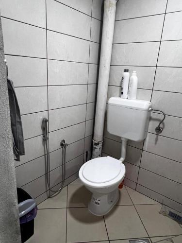 a bathroom with a white toilet in a room at REBL Suites in Sutješčica