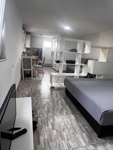 a bedroom with a bed and a desk and a room with a bed gmaxwell gmaxwell at REBL Suites in Sutješčica