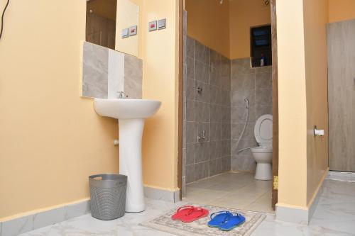 a bathroom with a sink and a toilet at Maria Villa Studio in Voi