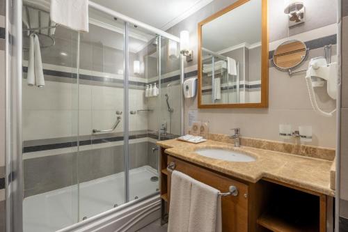a bathroom with a shower and a sink at Adalya Ocean Deluxe - Ultra All Inclusive in Side