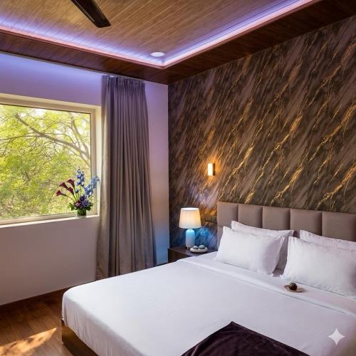 a bedroom with a large bed and a window at Hotel nine hearts in Pānīpat